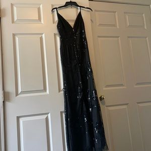 Beautiful showpo long black gown, with sequence details and slit.